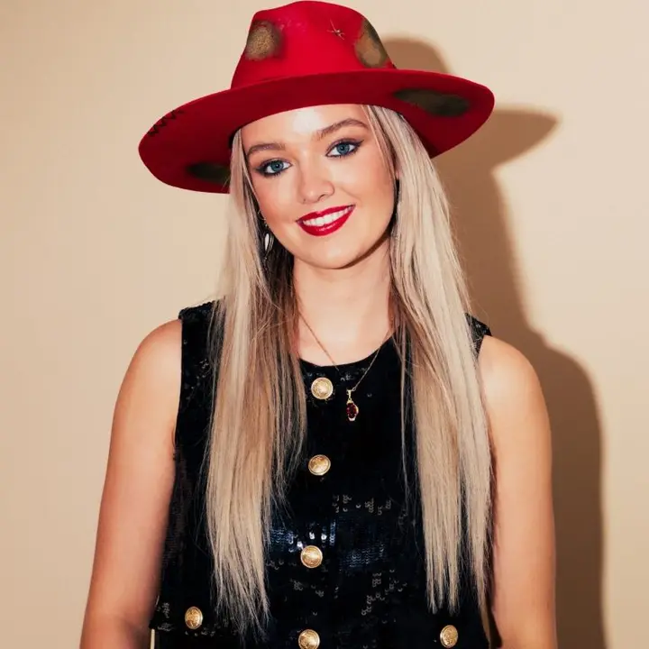 Robyn Red wearing a red hat